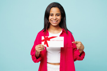 Little kid teen girl wear pink shirt white t-shirt hold point finger on gift certificate coupon...