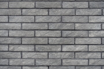 Surface of gray artificially aged brick veneer wall