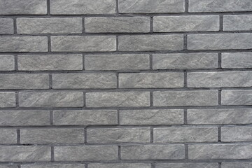 Fototapeta premium Texture of gray artificially aged brick veneer wall
