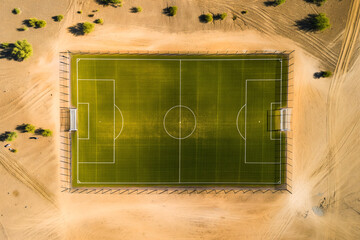 Soccer Pitch Located on the Desert Landscape. Grass Football Venue Surrounded by Sand Dunes