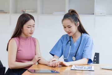 Fototapeta premium Asian female doctor and female patient while explaining in hospital.