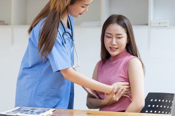 Fototapeta premium Asian female doctor examining breast cancer patients in hospital.