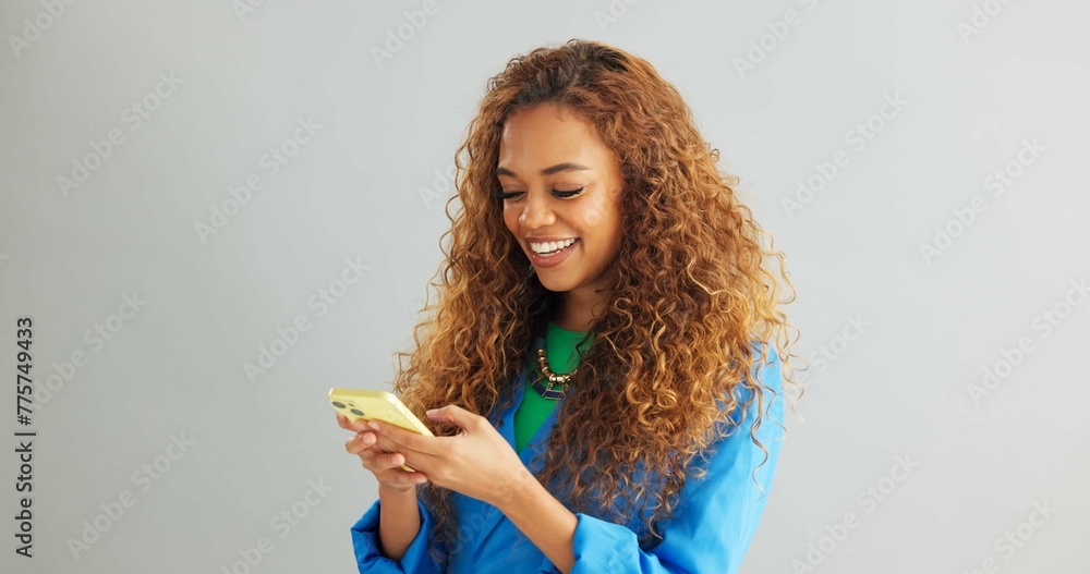 Aufkleber happy woman, typing and networking with phone for social media or communication on a gray studio bac
