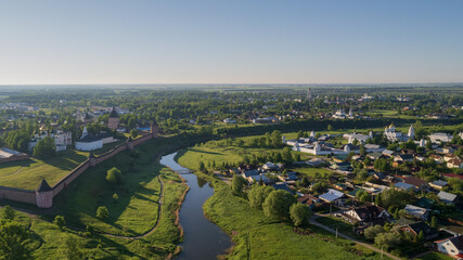 Panoramic aerial view of ancient city Suzdal and Saviour Monastery of St. Euthymius at sunset. Golden ring of Russia, Vladimir region. Aerial drone photo. - obrazy, fototapety, plakaty