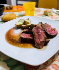 Sliced ​​duck breast with balsamic vinegar sauce, with a side of salted new potatoes. Romantic dinner. Italian culinary delicacy.  Mediterranean cuisine. Modern husband cooking.