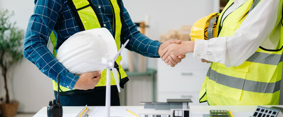 Engineer and contractor join hands after signing contract,They are having a modern building project...