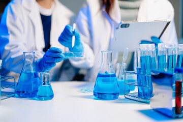 Fototapeta premium Scientist team meeting and writing analysis results in the laboratory study and analyze scientific