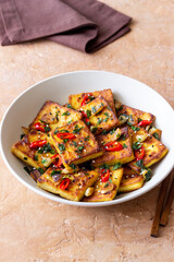Fried tofu with peppers, garlic and herbs. Vegetarian food. Healthy eating. Diet.