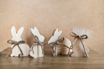 Easter toys. Set of wooden bunny on recycled brown paper background, copy space.