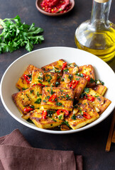 Fried tofu with peppers, garlic and herbs. Vegetarian food. Healthy eating. Diet.