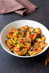 Fried tofu with peppers, garlic and herbs. Vegetarian food. Healthy eating. Diet.