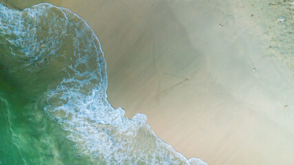Beach and waves from top view. Turquoise water background from top view. Summer seascape from air. Top view from drone. Travel concept and idea.