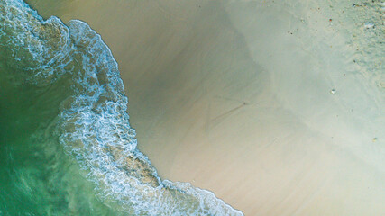 Beach and waves from top view. Turquoise water background from top view. Summer seascape from air. Top view from drone. Travel concept and idea.