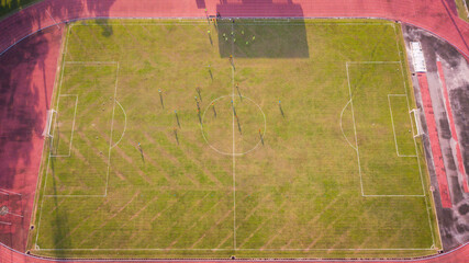 Aerial Top Down View of Soccer Football Field and Two Amateur Teams Playing. Passing, Dribbling,...