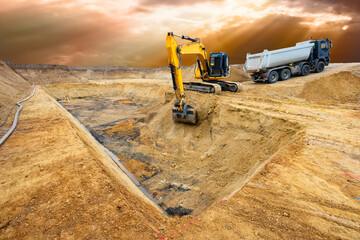 excavator is working and digging at construction site - 775775410