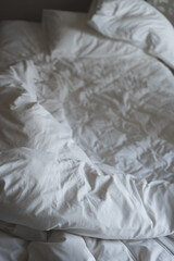 Crumpled blanket, wrinkled bed sheet on bed in the home or hotel bedroom