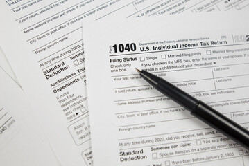Tax time concept. Tax form with office supplies on white. financial document.