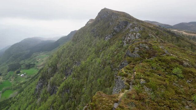 Drone video of Stolanuten cliff and hill top in Nedstrand, Norway, overlooking Lysevatnet Lake.