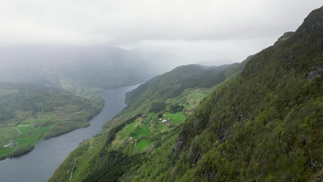 Drone video of Stolanuten cliff and hill top in Nedstrand, Norway, overlooking Lysevatnet Lake.