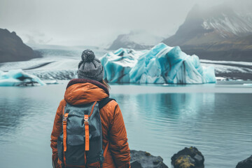 Tourist exploring majestic Icelandic glacier lagoon. Wonderful nature of Iceland.