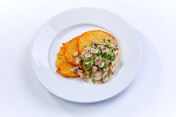 potato pancakes  with mushrooms on white plate - 775793683
