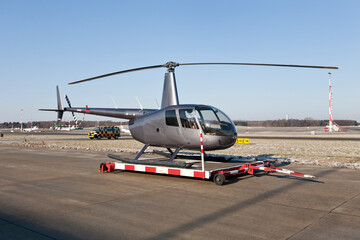 Obraz na płótnie Canvas helicopter on the airfield at airport in front of blue sky