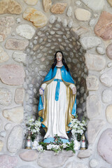 CZARNY DUNAJEC, POLAND - MARCH 29, 2024: Fatima Grotto with a statue of Our Lady in the garden of...