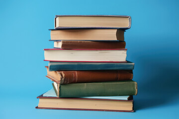A stack of books on a blue plain background. Knowledge day, back to school