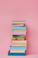 books on a pink plain background. back to school.