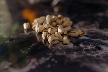 Sack with pistachios on a wooden table.