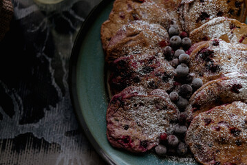 pancakes with raspberries in white plate