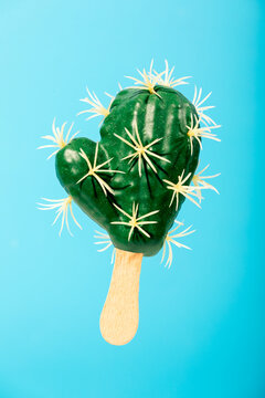 Cactus-shaped popsicle on a blue background