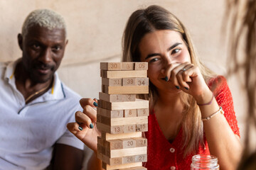Group of friends playing a wooden block game