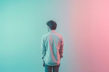 A man is standing in front of a wall with a pinkish blue background - Powered by Adobe