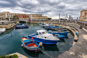 Fishing boats in port of Syracuse city, Sicily Island, Italy