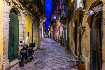 Narrow street on Ortygia island, old part of Syracuse city, Sicily, Italy