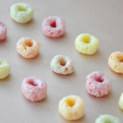 Row of Colorful Fruit Loops Cereal on Background