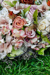 Beautiful outdoor weeding decoration made of artificial flowers. Traditional romantic motifs.