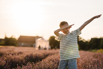 Happy young american guy performing show dance on summer day at sunset. Cheerful child presenting...