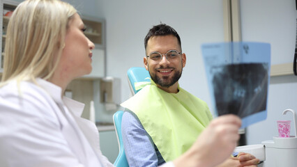 Dentist and patient making a treatment plan together