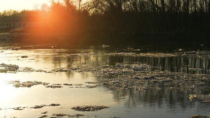ice melts river sunset current, glowing evening ripples, riverside sunset atmosphere, sunset...