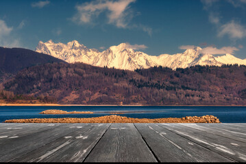 late autumn view of mountains. beautiful lake with empty wooden table. Natural template landscape