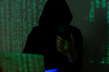 Hacker using cell phone for hacking