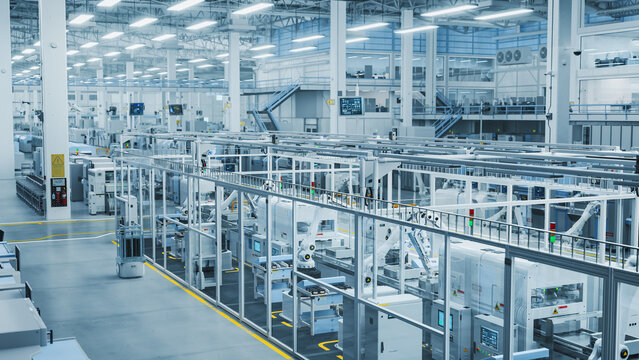 3D Render: Advanced Robot Arm Conveyor Line Manufacturing Electronics Enclosure Boxes. High Angle Shot with Artificial Intelligence Assembly Line Building HighTech Products for the Technology Industry