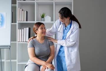 Fototapeta premium Female doctor and elderly female patient consulting about health problems in clinic