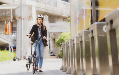 Eco friendly vehicle, businesswoman ride bicycle in urban downtown to reduce carbon footprint....