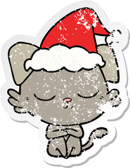 cute hand drawn distressed sticker cartoon of a dog wearing santa hat