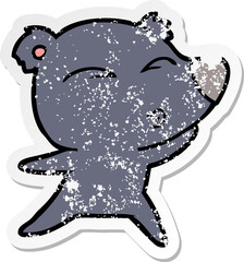 distressed sticker of a cartoon whistling bear