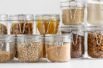 food storage, culinary and storage concept - jars with different cereals or groceries on table