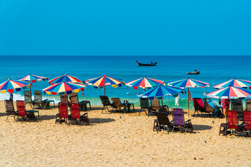 Karon Beach, one of the favorite beaches visited by tourists to play in the water, sunbathe or just enjoy the tropical climate in Phuket, Thailand. The beauty of Karon beach on a hot day